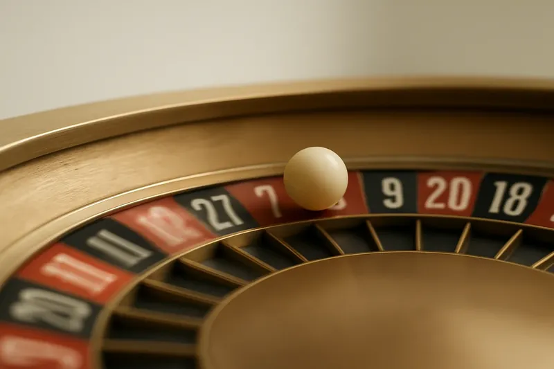 Roulette ball frozen mid-roll on wheel rim above blurred numbers